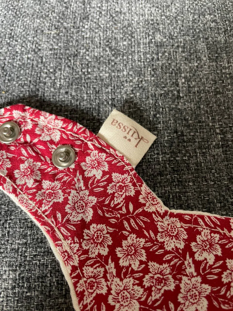 A flower-shaped Kiissa bib in vintage red floral cotton