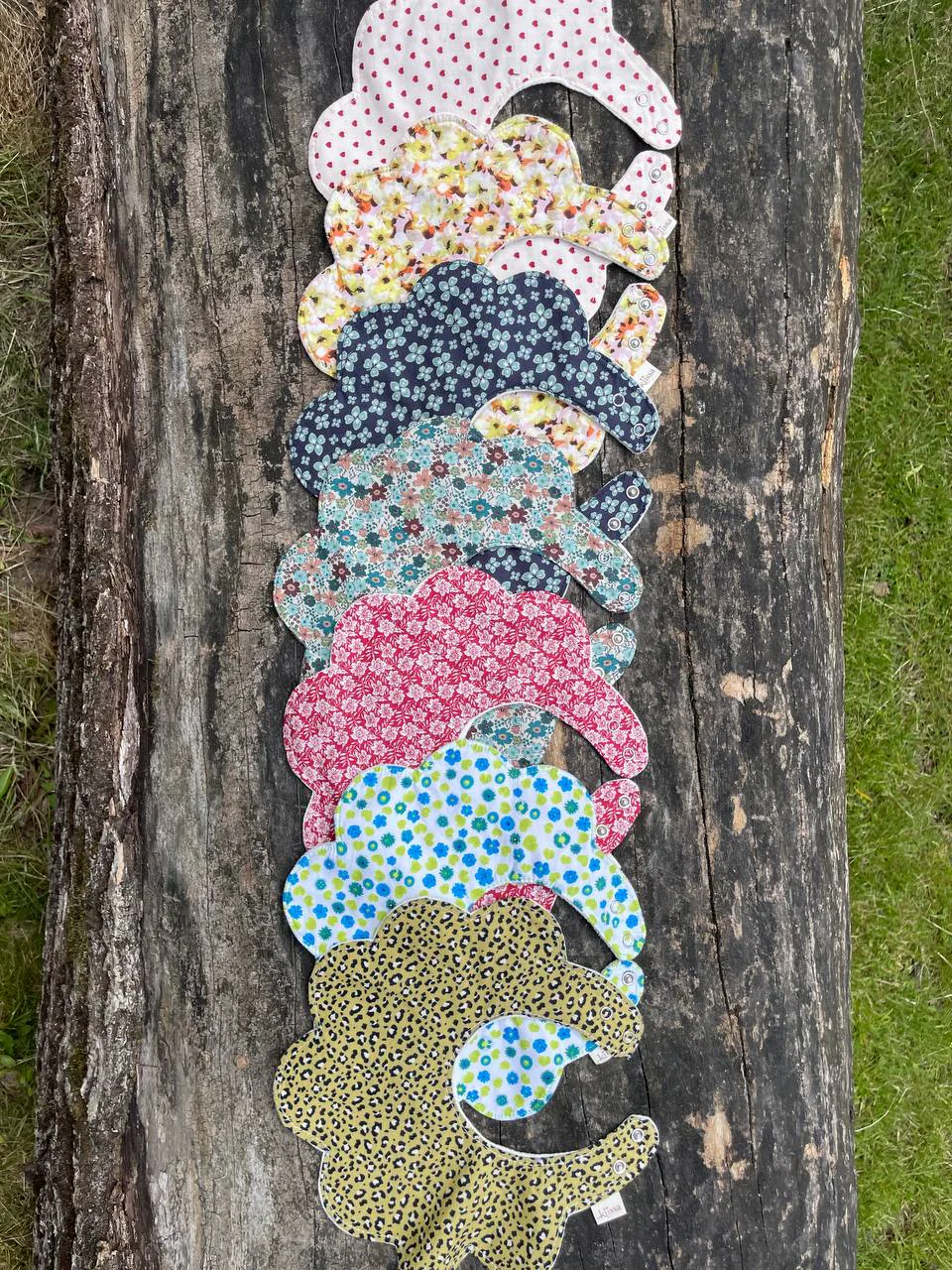 A long row of flower bibs laid down an old log