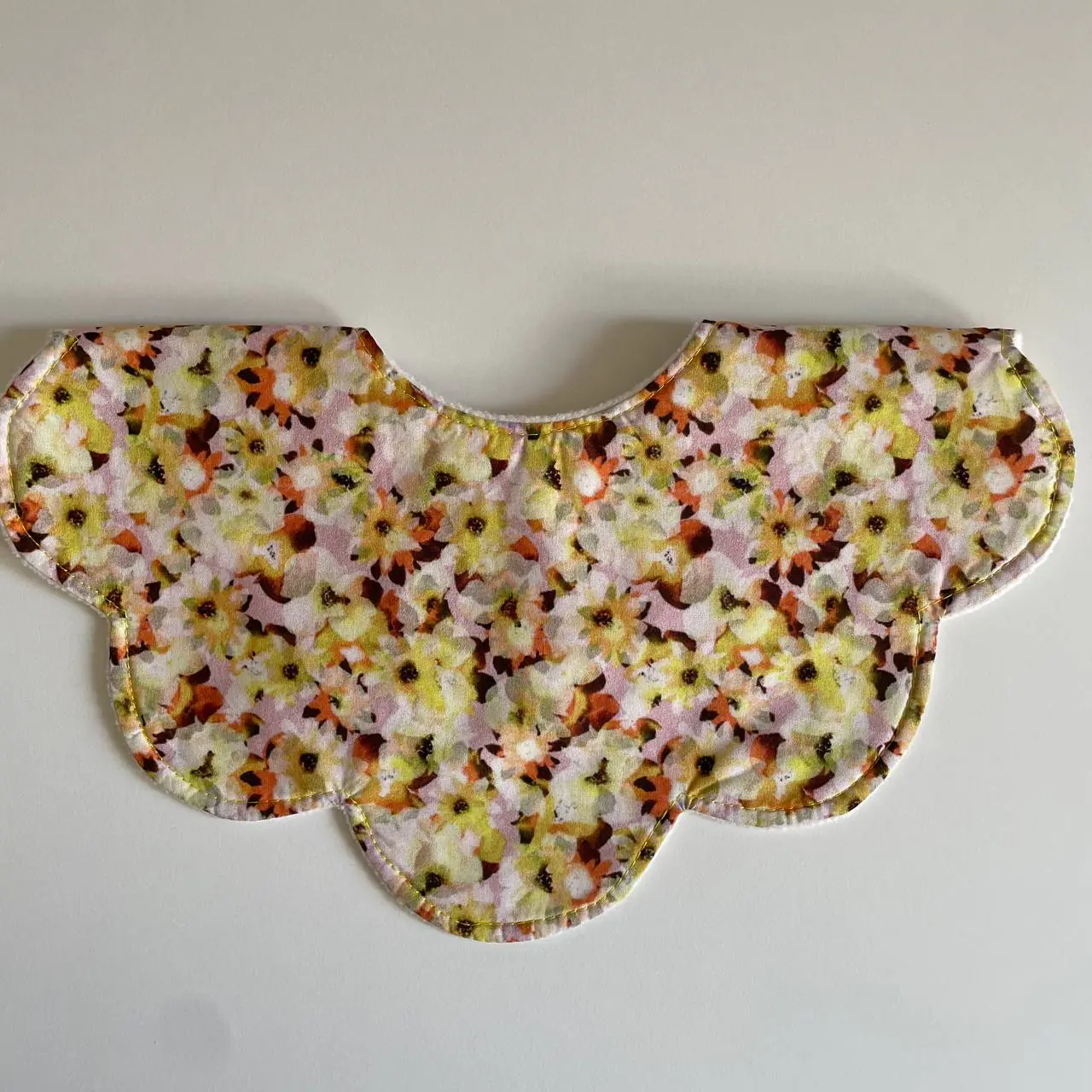 A scalloped collar in the meadow print